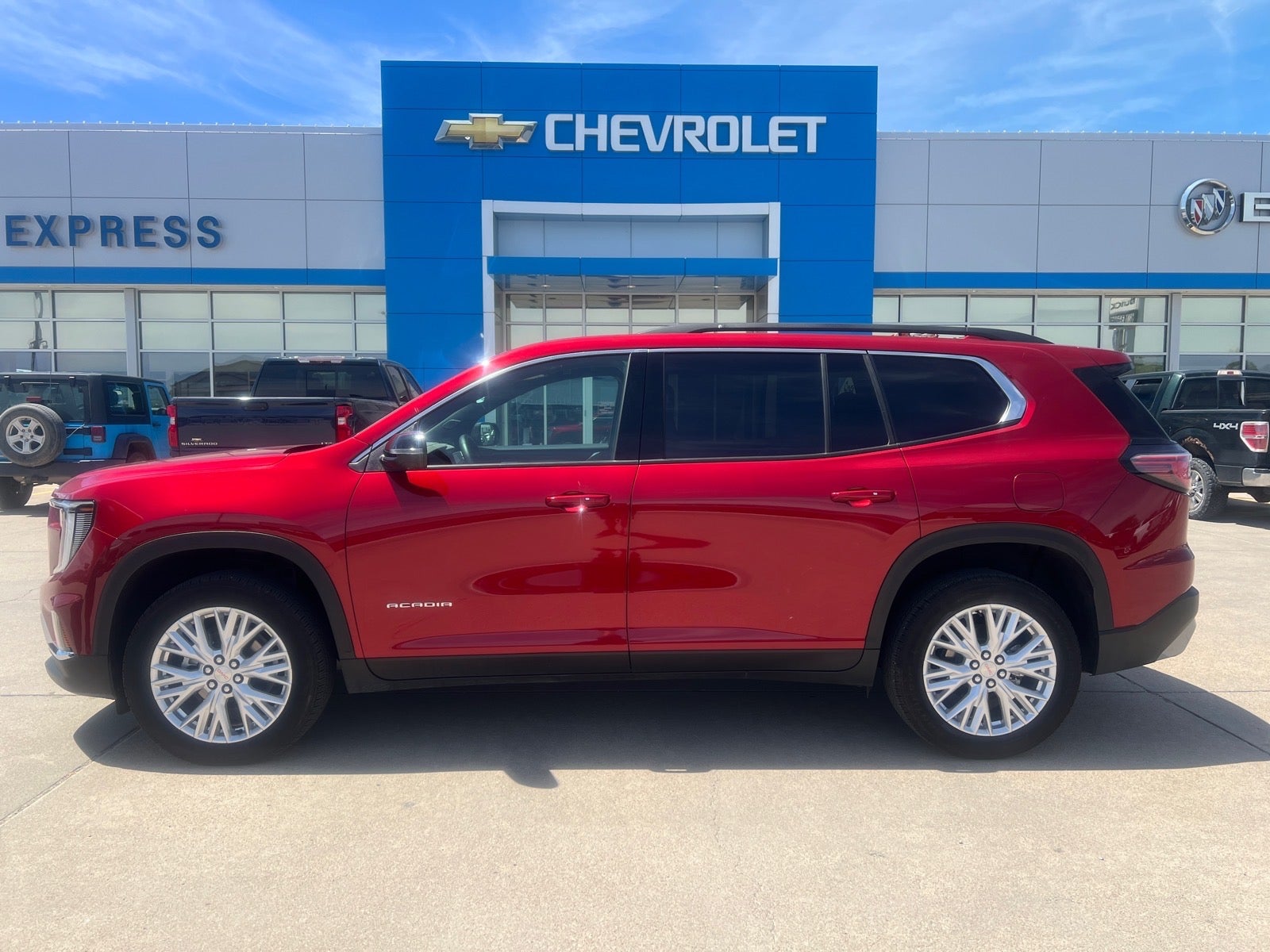 2026 GMC Acadia Elevation in Volcanic Red Tintcoat — front three-quarter view